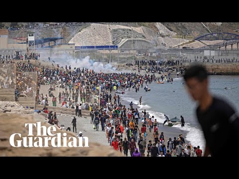 Migrants met by Spanish military as they swim to north African enclave Ceuta