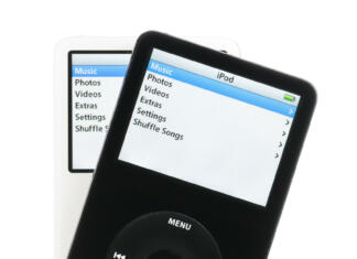 Colorado Springs, Colorado, USA - May 25, 2011: A pair of black and white iPods fanned out over a white background. Both iPods are displaying their home screens. The iPods in this photo are fifth generation Apple iPods. This model was the first iPod with video playback capabilities.