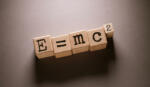E = mc 2 Word Written on Wooden Cubes