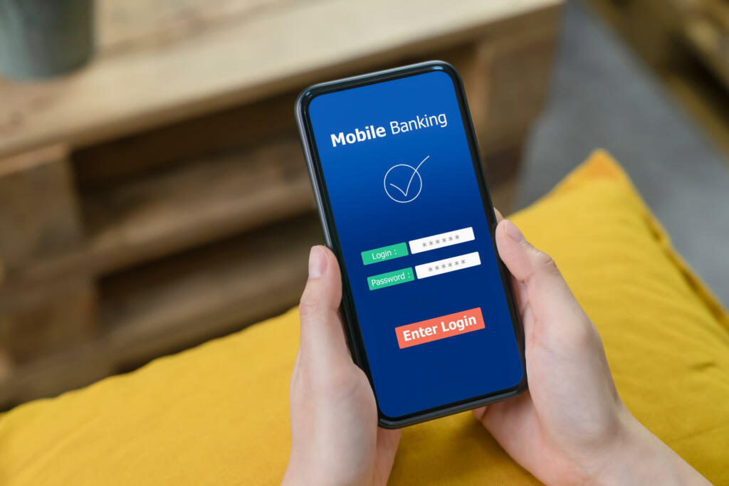 Female hands using mobile banking on smartphone and enter password to login application.