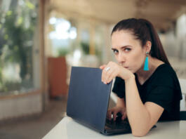 Girl trying to keep her internet data confidential typing password in secret
