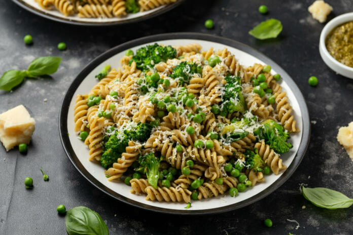 Green peas, broccoli pasta with pesto sauce and parmesan cheese. healthy food