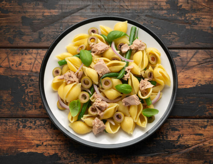Italian Tuna conchiglie pasta with green beans, olives and red onion. Healthy diet food.