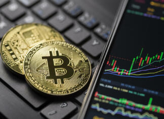 Bitcoin je že tretjič v enem tednu dosegel rekordno vrednost Ljubljana, Slovenia - may 12 Bitcoin gold cryptocurrency trading chart on smartphone close up.