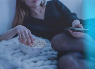 5 najbolj pričakovanih serij leta 2022 (po našem izboru) Dekle, ki leži v postelji in je pokovko, ter z dalinjcem upravlja TV