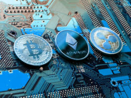 Prague, Czech Republic - May 23, 2018: Bitcoin, Ethereum and Ripple coins - largest cryptocurrencies by market capitalization lying on computer motherboard on May 23, 2018 in Prague, Czech Republic.