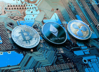 Sprememba v kodi, ki lahko zmanjša porabo energije v rudarjenju bitcoinov za 99 % Prague, Czech Republic - May 23, 2018: Bitcoin, Ethereum and Ripple coins - largest cryptocurrencies by market capitalization lying on computer motherboard on May 23, 2018 in Prague, Czech Republic.