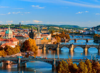 Zlato mesto ob Vltavi View of the Vltava River and Charle bridge with red foliage, Prague, Czech Republic