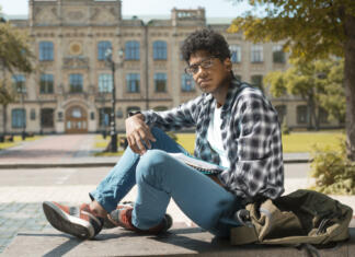 Preselitveni roki Študentskih domov African American boy student stands near the Polytechnic University in Kiev.