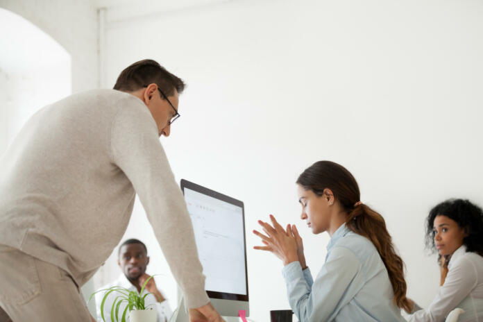 Angry boss scolding criticizing firing stressed intern for incompetence in multiracial office, sad frustrated employee receives unfair reprimand rebuke, suffers from bad attitude of executive at work