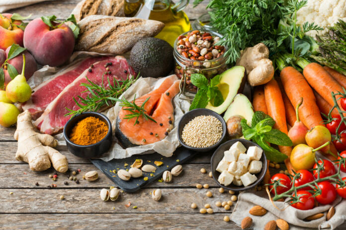 Balanced nutrition concept for clean eating flexitarian mediterranean diet. Assortment of healthy food ingredients for cooking on a wooden kitchen table.