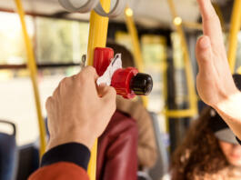 cropped shot of man validating bus ticket in public transport
