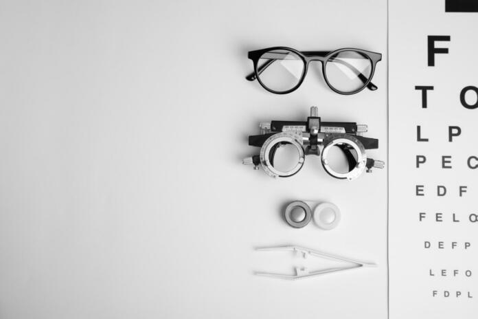 Different ophthalmologist tools on white background, flat lay