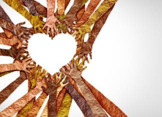 NEKAJ BESED O SOLIDARNOSTI Diverse hands heart and united diversity or unity partnership in a group of multicultural people connected together shaped as a support symbol expressing the feeling of teamwork and togetherness.