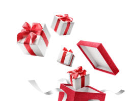 Gifts bursting out from red open gift box over white background