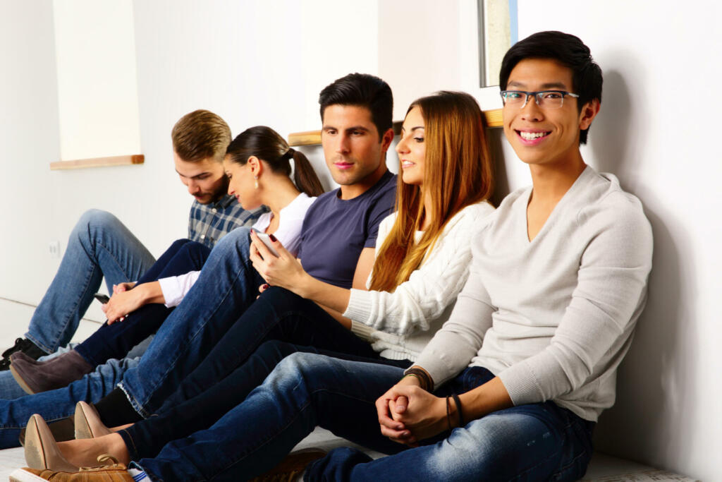 Group of a happy friends sitting on the floor