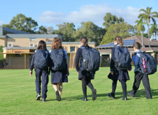 Kam po končani srednji šoli? Group of Australian school students wearing school uniform walking together to school in the morning time.
