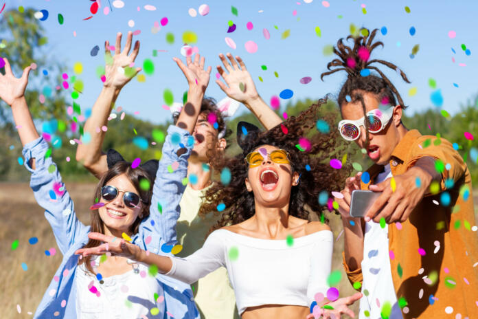 happy-excited-friends-having-fun-outdoor-celebrating-with-confetti-young-millenial-people-enjoying-summertime-together-at-garden-party-cheerful-friendship-concept-party-festival-concept-stockpack-istock Happy excited friends having fun outdoor celebrating with confetti - Young millenial people enjoying summertime together at garden party - Cheerful friendship concept. Party - festival concept.