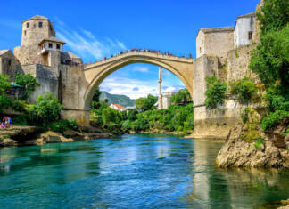 Balkan trip Historical Stari Most (Old Bridge) and Koski Mehmed Mosque in the Old Town Mostar on Neretva River, Bosnia and Hercegovina