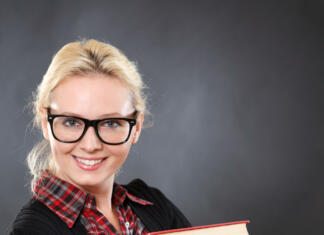 Vas zanima kako inteligentni ste? Inteligent woman in glasses with books.Black background.