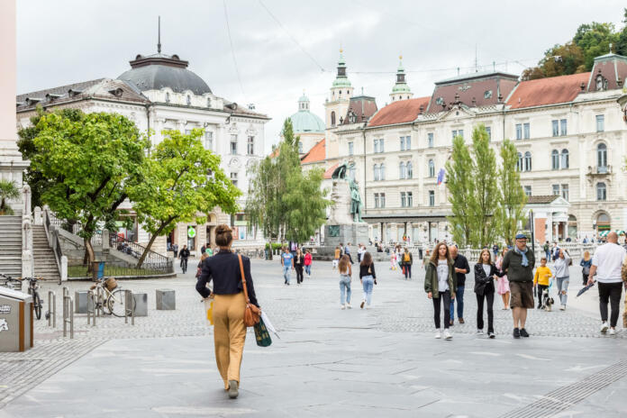 Ljubljana, Slovenia - 23 August, 2021: People walking in the historical city center Preseren square near Triple Bridge (Tromostovje) in Ljubljana, Slovenia