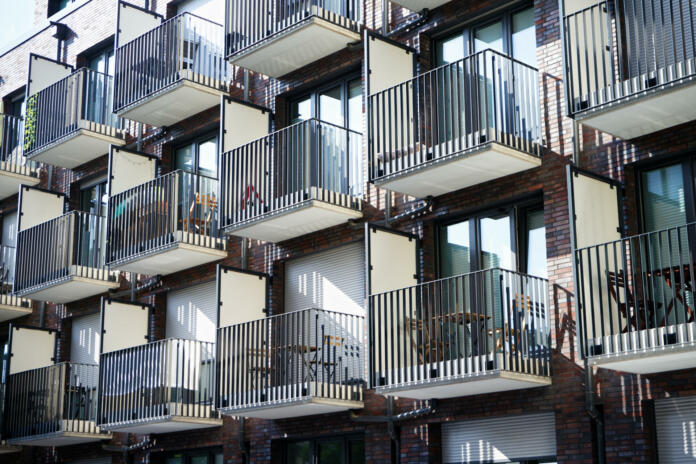 many small balconies with tables and chairs at a student residence in cologne