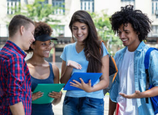 Arne Hodalič: „Želel sem si jadrnico in sem jo tudi naredil.“ Multi ethnic male and female students in discussion outdoor in summer in city