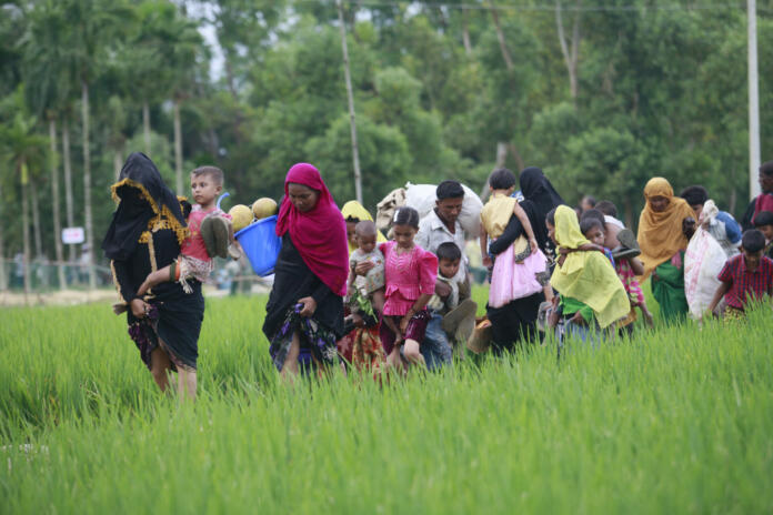 Rohingya Muslims, who crossed over from Myanmar into Bangladesh, walks through muddy field to take shelter at Balukhali refugee camp, Bangladesh, October 2, 2017. The United Nations' humanitarian office said Thursday that the number of Rohingya Muslims fleeing to Bangladesh since Aug. 25 has topped 500,000.