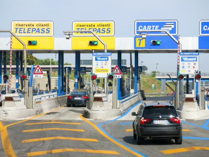 Rome, Italy - July 29, 2013: Cars at toll booths of Autostrade, the motorway to Rome - payment with telepass or card