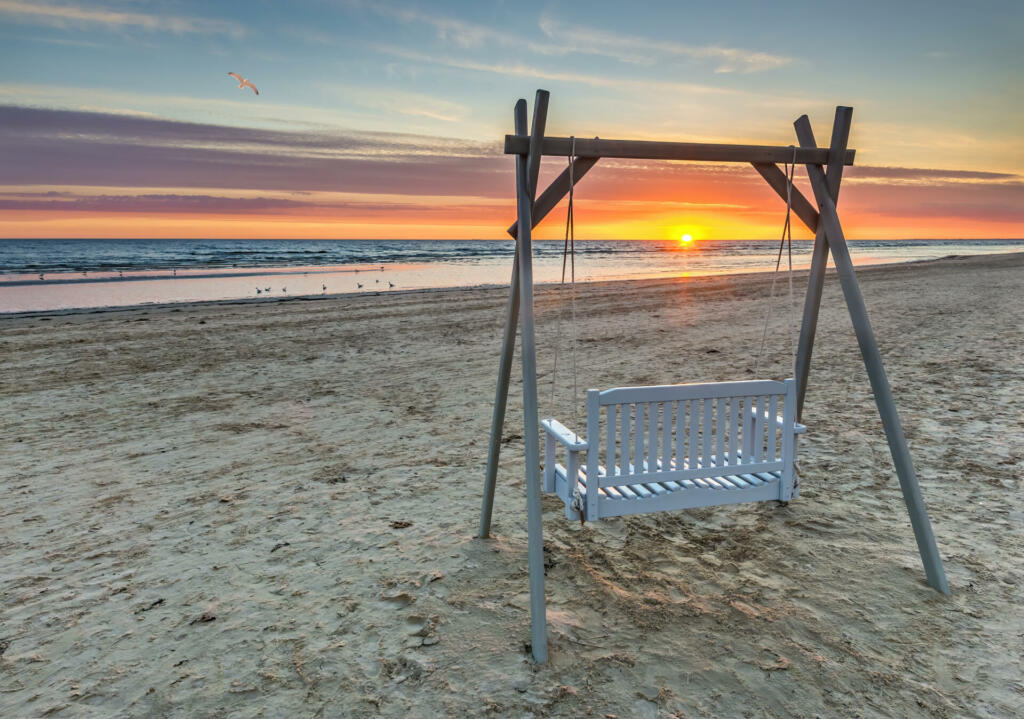 Sunrise on sandy beach of the Baltic Sea in Jurmala - famous tourist resort in Latvia, Europe