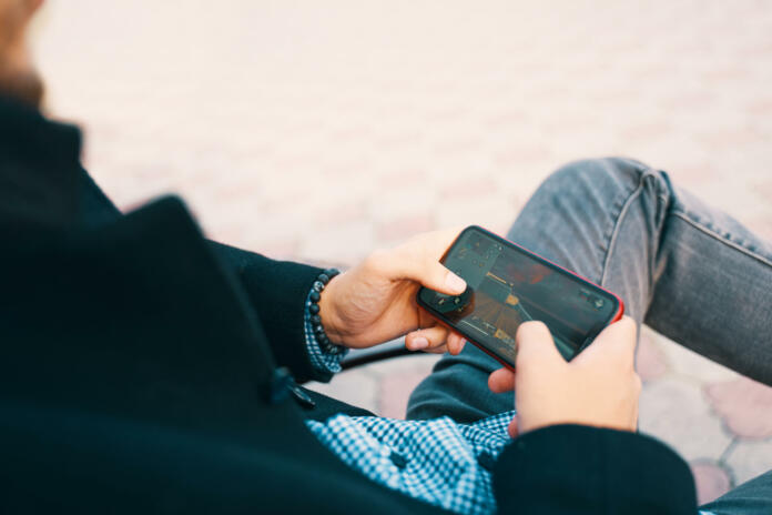 Bishkek, Kyrgyzstan - October 10, 2019: Man playing online game in call of duty mobile on iphone 11