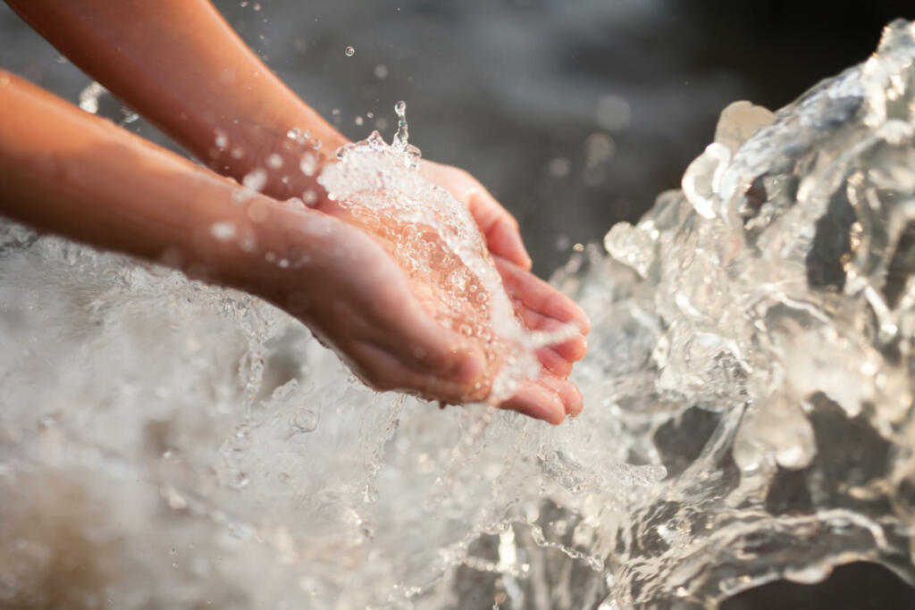 Children drinking water from public tap, Water scarcity impact concept.