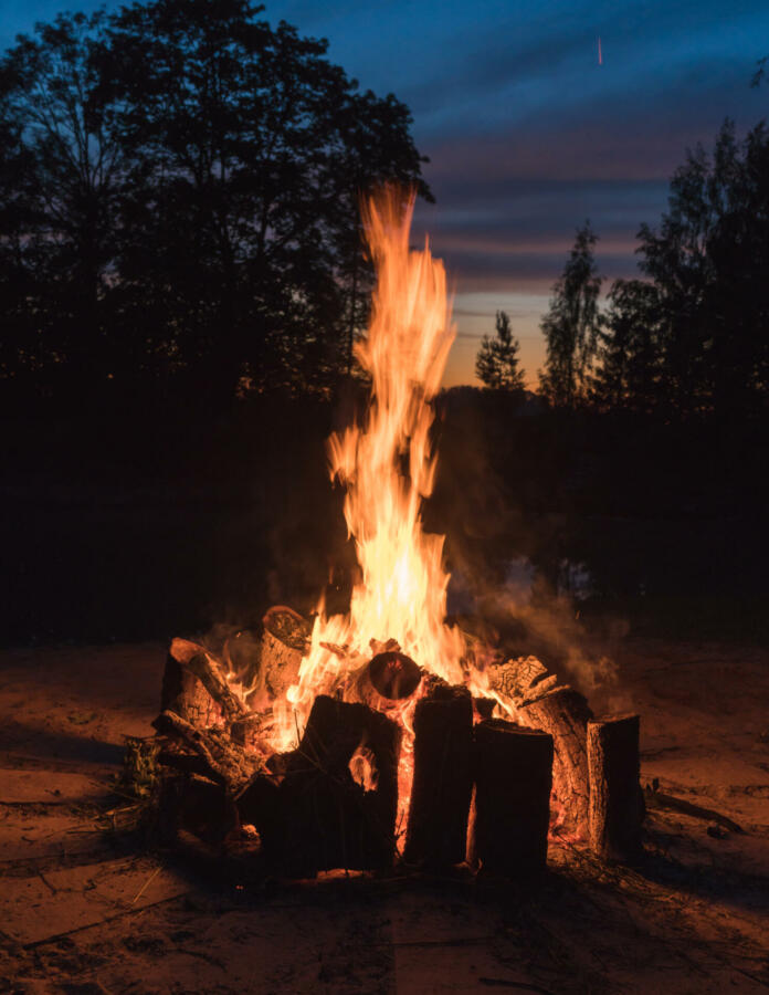 close-up fire, large burning blocks of wood and flames of red fire at the summer solstice