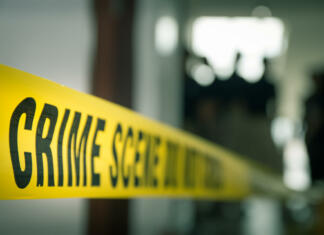 Najhujši serijski morilci vseh časov crime concept by police line tape with blurred forensic law enforcement background in cinematic tone and copy space