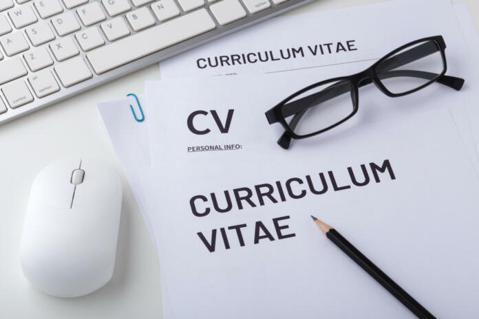CV, curriculum vitae with computer keyboard and mouse, job interview