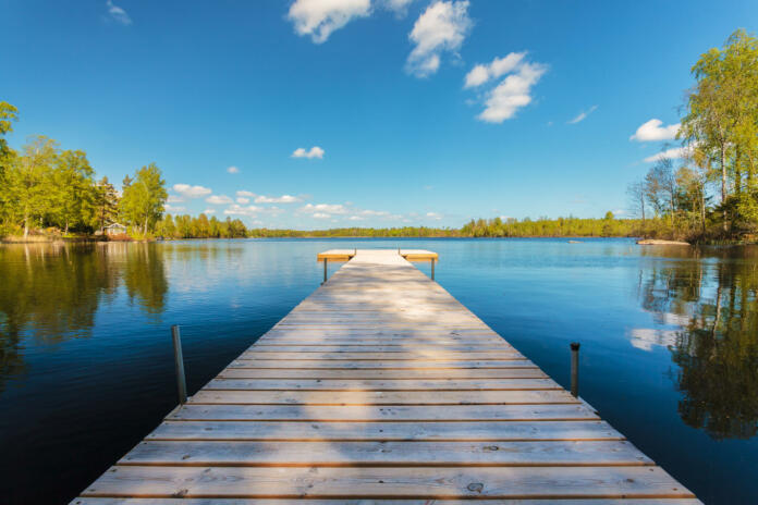 Deserted wooden jetty on a sunny day in the province of Smaland in Sweden