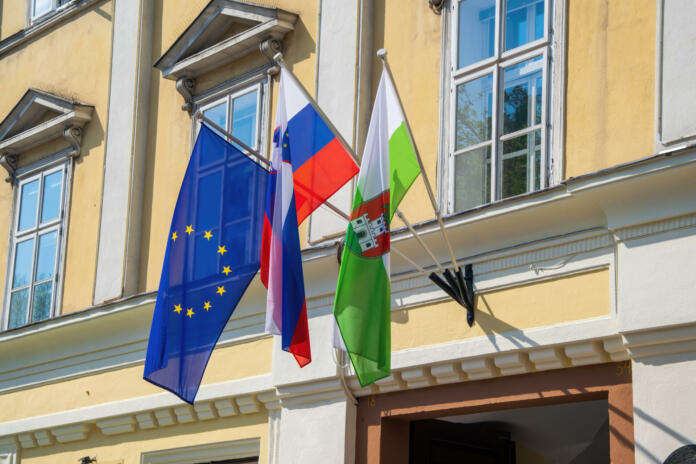 European, Slovenian national and Ljubljana city flags on the wall of town hall in the center of Ljubljana - capital of Slovenia