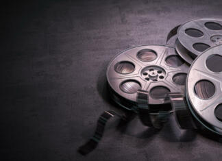 Najboljši filmi leta 2020 Film reels on black background. Movie, video and cinema prodaction and edition concept. 3d illustration