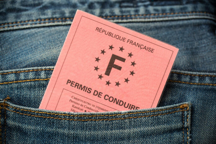French driving license in the rear pocket of blue jeans, driving licence test concept