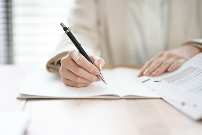 Hands of an Asian woman studying in a coworking space