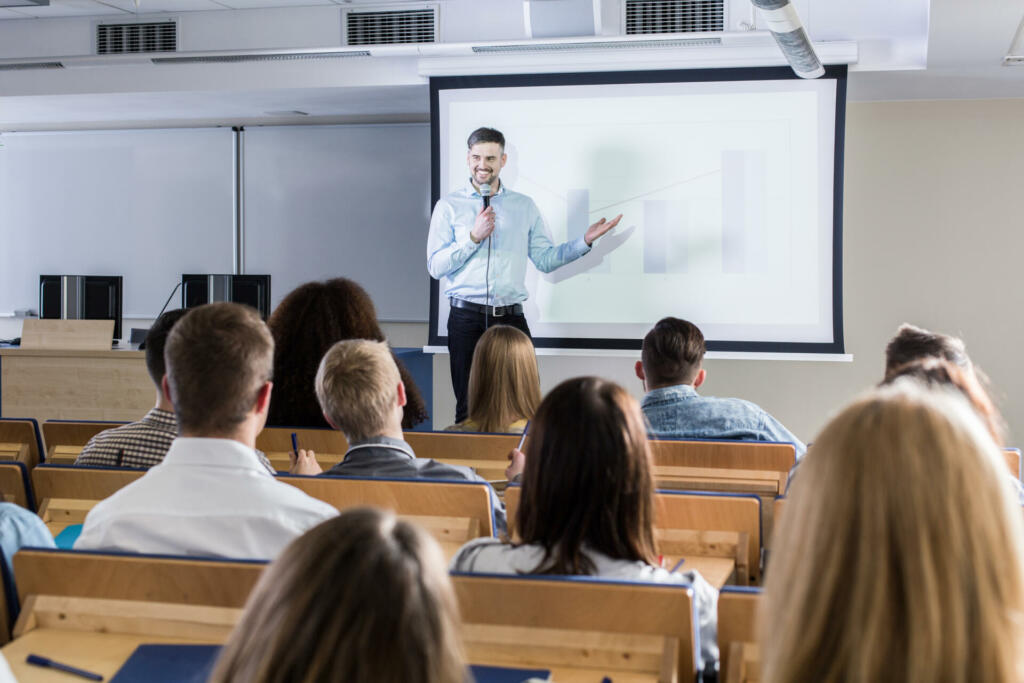 Image of a teacher giving a lecture to his students