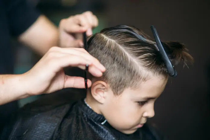 little-boy-on-a-haircut-in-the-barber-sits-on-a-chair-stockpack-istock Little boy on a haircut in the barber sits on a chair.