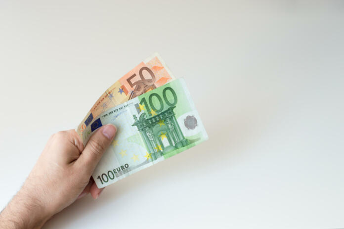 Man holding a hundred and fifty  Euro banknote in his handsMan holding a hundred and fifty Euro banknote in his hands