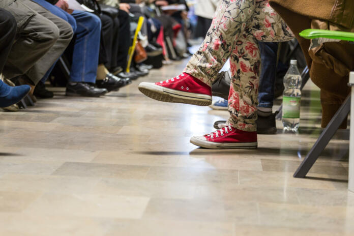 Many people in a waiting room to see a doctor