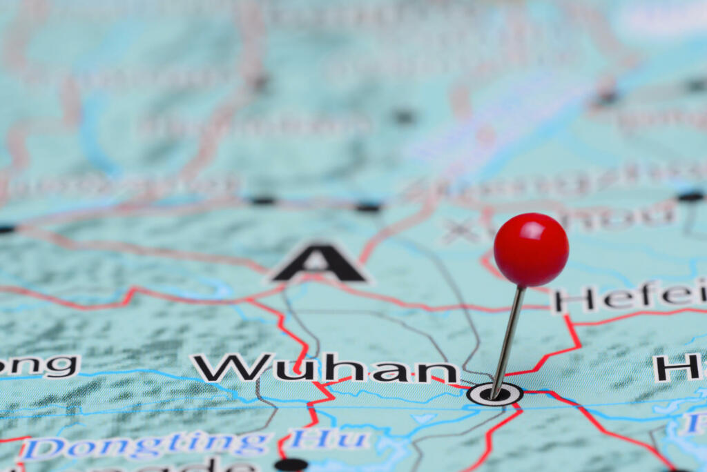 Photo of pinned Wuhan on a map of Asia. May be used as illustration for traveling theme.