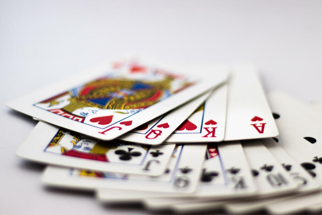 Playing cards with banknotes and coins for gambling