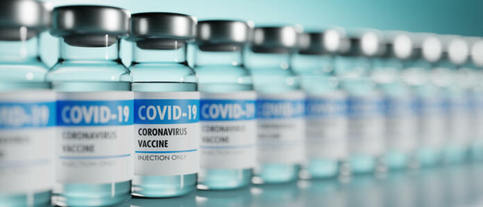 Row of Coronavirus vaccine flasks. Shallow depth of field. 3D render. 3D illustration.
