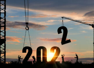 Zbiranje predlogov za državna priznanja mladinskega sektorja v letu 2022 Silhouette of construction worker with crane and cloudy sky for preparation of welcome 2022 new year party and change new business.