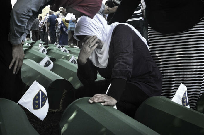 Since 2005, in July, people from all over the world have been arriving in Bosnia and Herzegovina to attend the funeral ceremony held for the victims of the genocide at the Potočari Memorial.Four hundred Dutch UN soldiers had the task of defending the territory of Srebrenica, declared an area under international protection. But it didn't happen. When Serbian troops on 11 July 1995 occupied Srebrenica under the command of General Mladic, UN soldiers retreated here to their base in Potocari and did not defend the city. The UN commands did not make the fighters intervene to stop the Serbs thus allowing the massacre.The coffins are covered with green canvas, inside there are the few remains of the killed person. A tag with a number remembers its name. Family members and relatives look for their loved one's coffin. They caress her, someone sits next to them and stays there for hours.