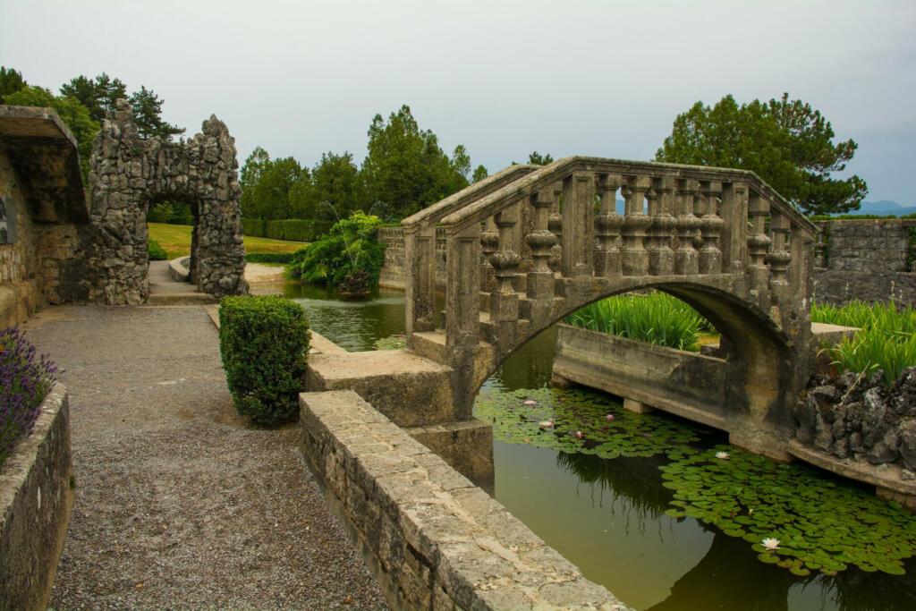 Stanjel, Slovenia - June 22nd 2022. The bridge to the island in the pond of the Ferrari Garden in Stanjel village, in Komen municipality of Primorska region, western Slovenia